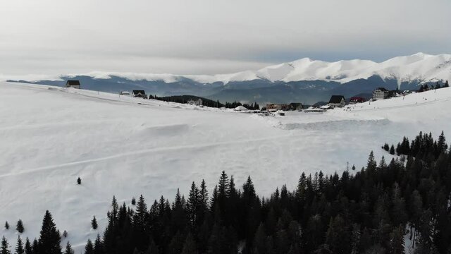 Majestic aerial view of Parangul Mare Peak covered with snow as ween from Ranca