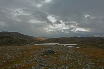 Norwegian tundra under a cloudy sky. Evocative landscape that recalls the cold lands of the vikings.