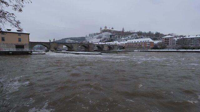 View of the River Main, Festung Marienberg, Alte Mainbr&uuml;cke and the K&auml;ppele on a cold gray winter day in W&uuml;rzburg. This beautiful historical german city is very rarely coverd in snow. 4K, no panning