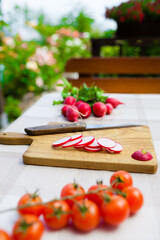 Radish cut into slices on cutting board in the garden. 