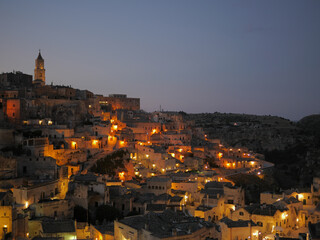 Evening view of the italian city of Matera with colorful warm lights.