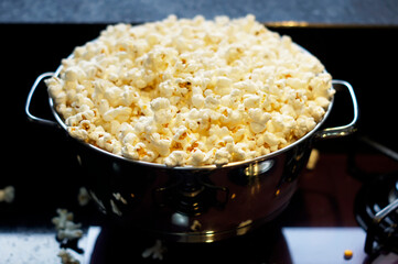 A stainless pan full of popcorn.