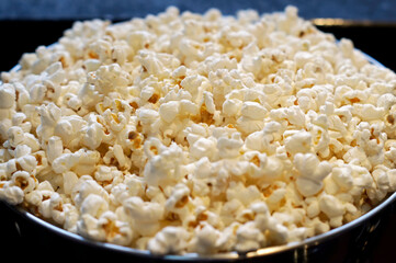 A stainless pan full of popcorn.