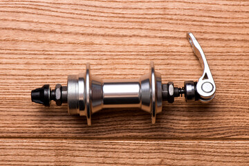 Mountain bike front hub bushing isolated on wooden background. Bicycle components. Cycling...