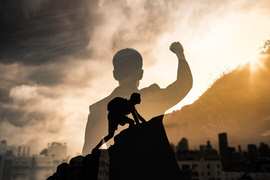 Never give up, mental strength and determination. Strong determined businessman in the city with fist in the air. 