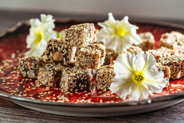 Turkish delight sprinkled with sesame seeds on a beautiful plate