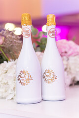 decor of champagne bottles on the background of a beautifully decorated newlyweds table