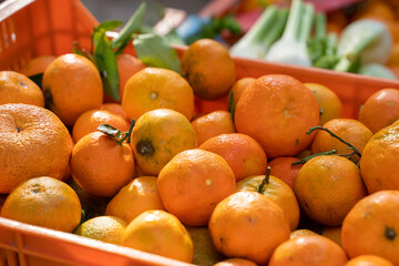 A stand of oranges in a basket at a market in Pollença in Palma de Mallorca, Spain