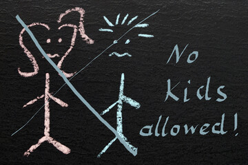 "no kids allowed" written on black chalkboard