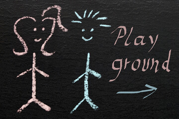 chalkboard with two drawn happy children and the written word "playground"