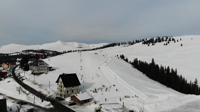 Aerial view raising up above the ski slope in Ranca resort on a cold winter day