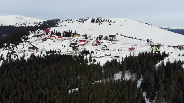 Beautiful aerial view of Ranca resort covered with snow in Parang Mountains on a cold winter day