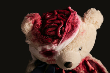 bear on a gray background close-up with a broken head. brains are visible. blood. halloween...
