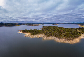 Drone aerial view of Idanha Dam Marechal Carmona landscape with beautiful blue lake water, in Portugal