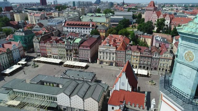 View from the drone on the old market square in Poznań. In the foreground, a church hoop. Historical tenement houses in the background.
