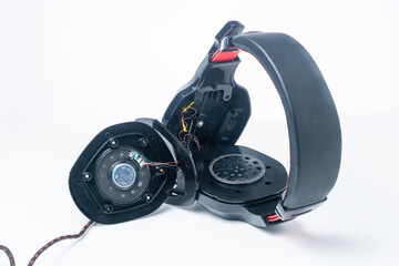 Disassembled computer headphones with a microphone for repair on a white background.