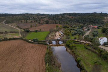 Fototapeta na wymiar Drone aerial view of an ancient historic stone bridge in Idanha a velha, Portugal