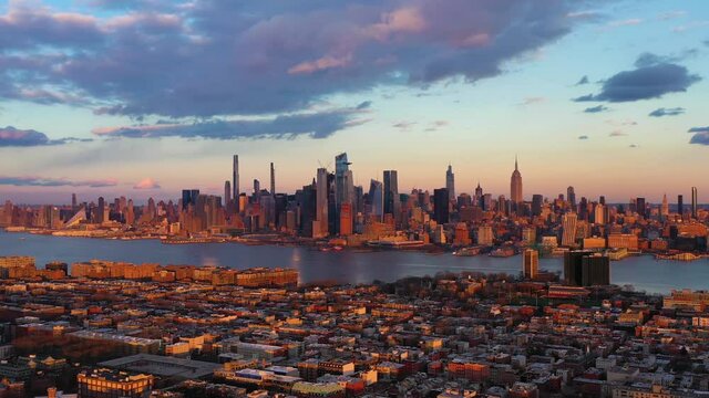 Urban Skyline of Midtown Manhattan, Hoboken and Hudson River at Sunset. Sunlight on Buildings. New York City, USA. Aerial View. Drone Flies Sideways