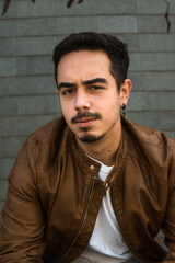 Fototapeta premium Boy in brown leather jacket posing