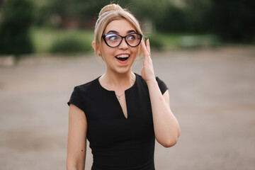 Portrait of surprised teacher outdoors. Woman in sunglasses