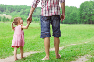 Fototapeta premium the parent holds the hand of a small child