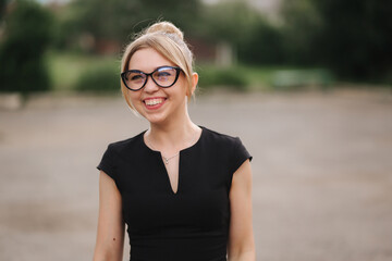 Portrait of surprised teacher outdoors. Woman in sunglasses