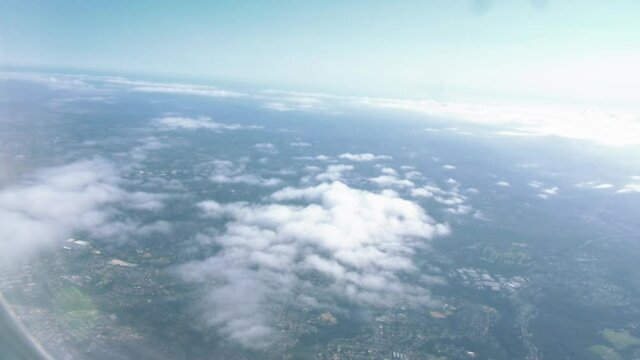 Flying Plane With A View On The Clouds And Landscape From The Window - Flight From Australia To Singapore - aerial, POV