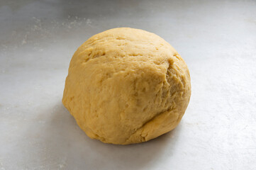 Preparing homemade pasta dough on a white marble background.