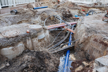Repair of communications. Water supply, sewerage electrician. repair works. Excavated road in the...