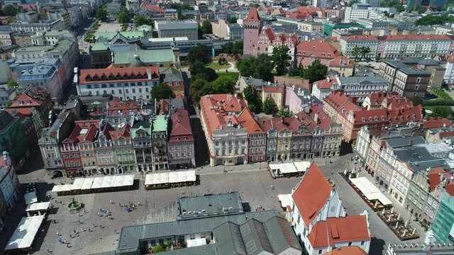 A drone view of most of the Old Market Square in Poznań. Visible colorful historic tenement houses, atmospheric streets and the newer part of the city