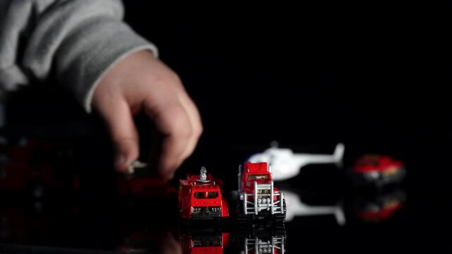 Red fire engine and fire brigade vehicle toys for saving operations, kid playing firefighter