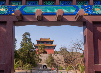 Beijing, China - April 28, 2010: Ming Tombs Changling. Memorial hall above brown stone rampart seen...