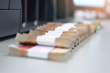Bundles of banknotes divided into groups with currency straps placed on the electronic counting machine