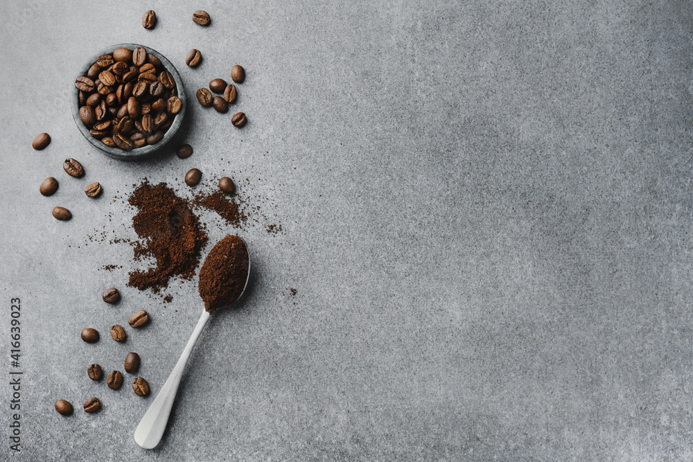 Wall mural coffee beans in bowl on grey background