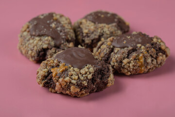 Chocolate cookies with nuts on a pink background