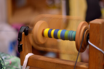 Coil Of A Spinning Wheel Rotates With Colored Wool