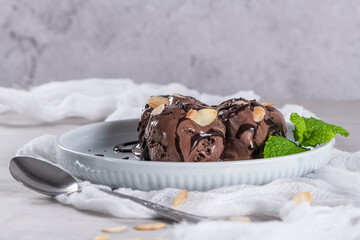 Delicious chocolate ice cream for dessert on plate with mint leaf