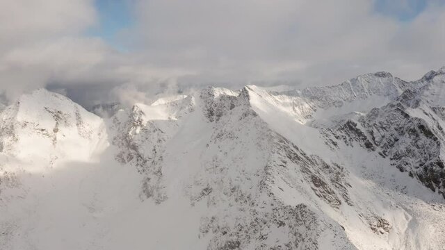 Panoramic Aerial Shot of Mountains Coveredin White Thick Snow During the Day