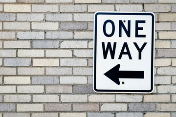 One Way Sign on a Brick Wall