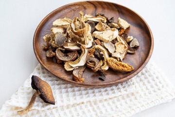 dried mushrooms on a wooden plate