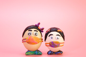 Fototapeta premium Funny Easter eggs wearing colorful face mask for Easter holidays decoration with Corona virus (COVID-19) protection concepts