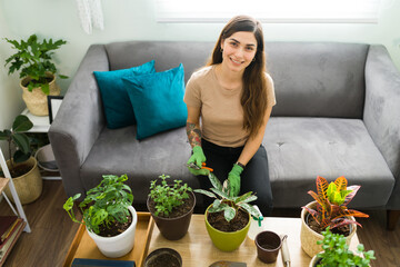 Portrait of a happy woman with her houseplants