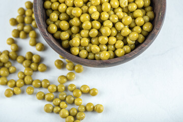 Top view of marinated green olives in bowl