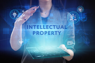 Business, Technology, Internet and network concept. Young businessman working on a virtual screen of the future and sees the inscription: Intellectual property