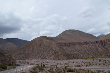 Fototapeta na wymiar Road trip. Traveling along the asphalt road across the arid desert and the mountains.