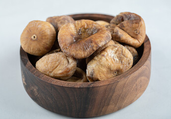 Delicious dry figs in wooden bowl
