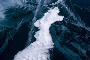 Perfect desktop wallpaper. Numerous streaks of cracks in the transparent blue clear ice. Amazing patterns. Horizontally. Baikal Lake, Russia