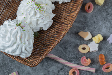 White meringue cookies in a wooden basket
