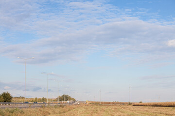 Rural landscape with a newly built freeway motorway road with traffic passing by over a concrete...