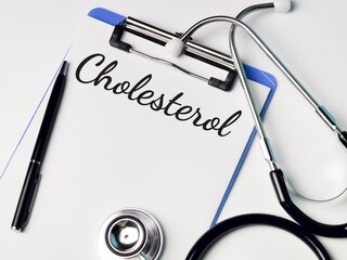 Medical and health concept. Phrase CHOLESTEROL written on paper clipboard with stethoscope and a pen. 